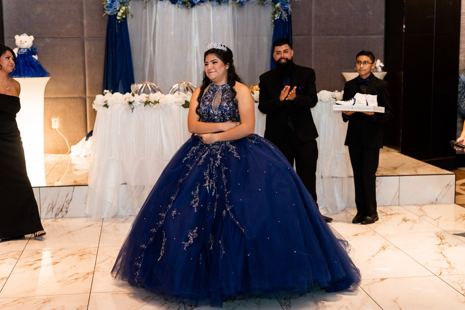 Quinceañera in a blue gown at her reception