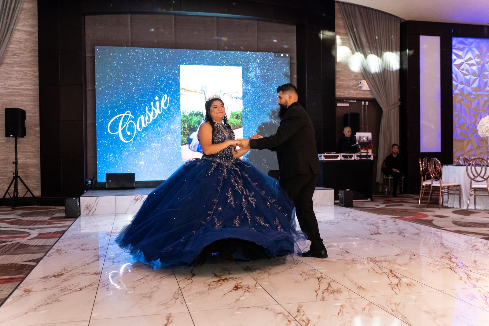 Quinceañera dancing with a family member