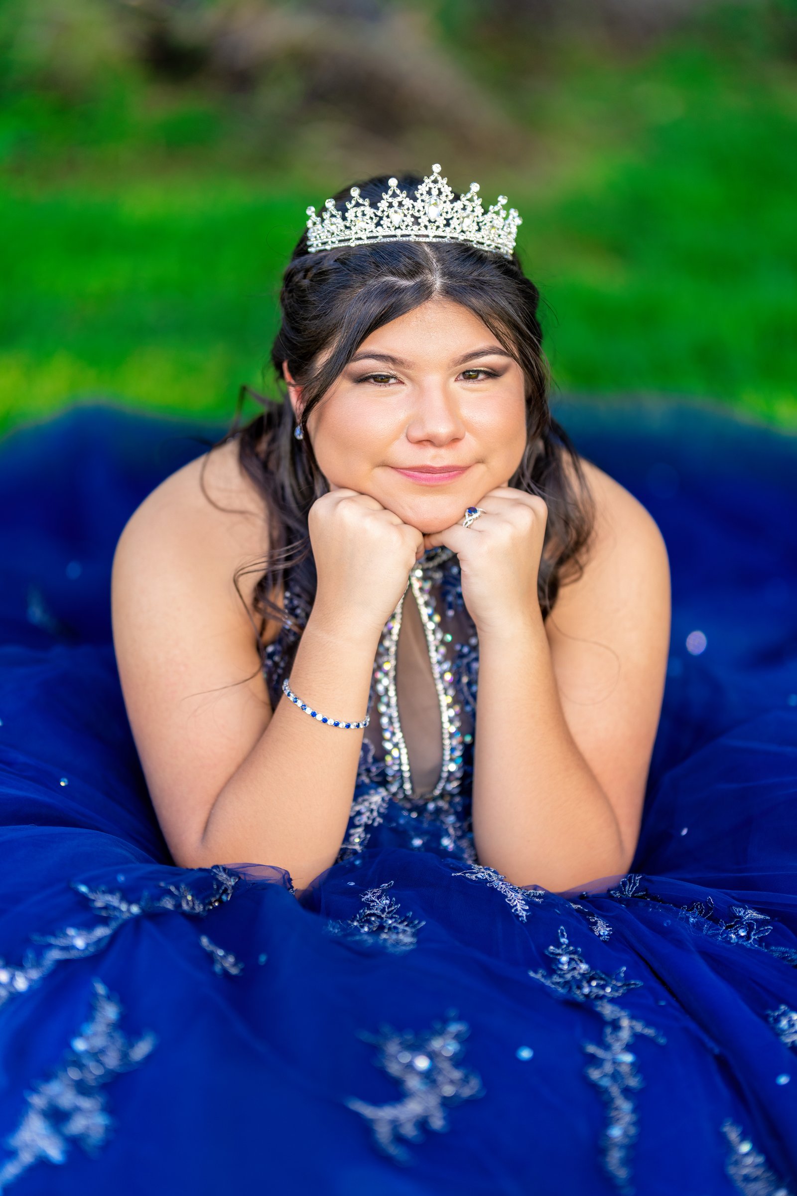 Close portrait with a tiara and blue quinceañera gown